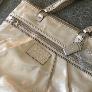 Beautiful metallic champagne colored COACH purse